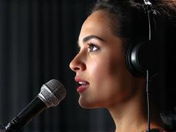 Person speaking into a microphone, representing communication training